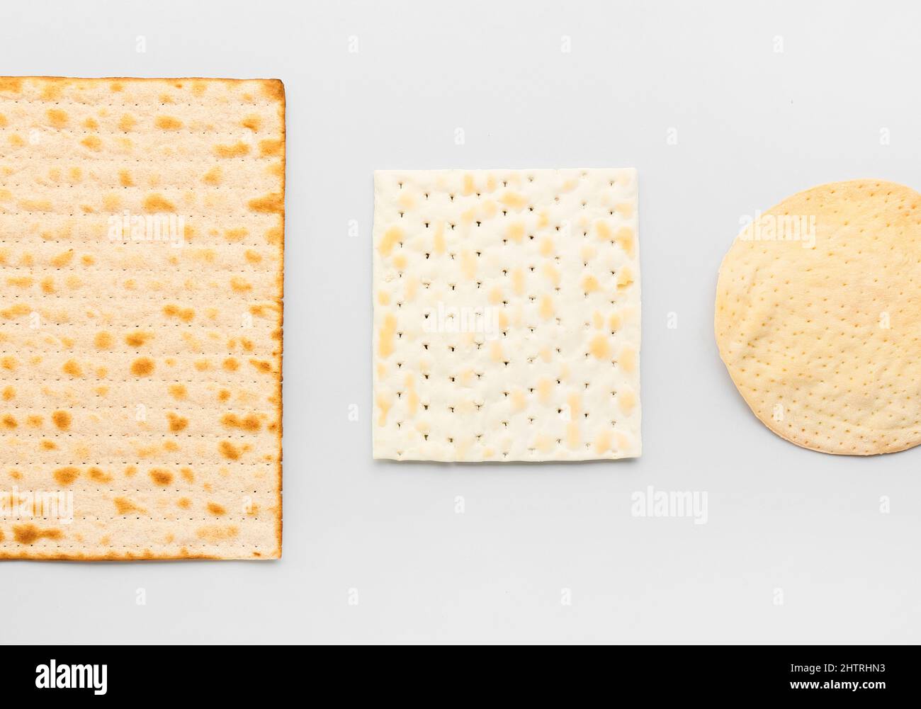 Different Jewish flatbread matza for Passover on light background Stock