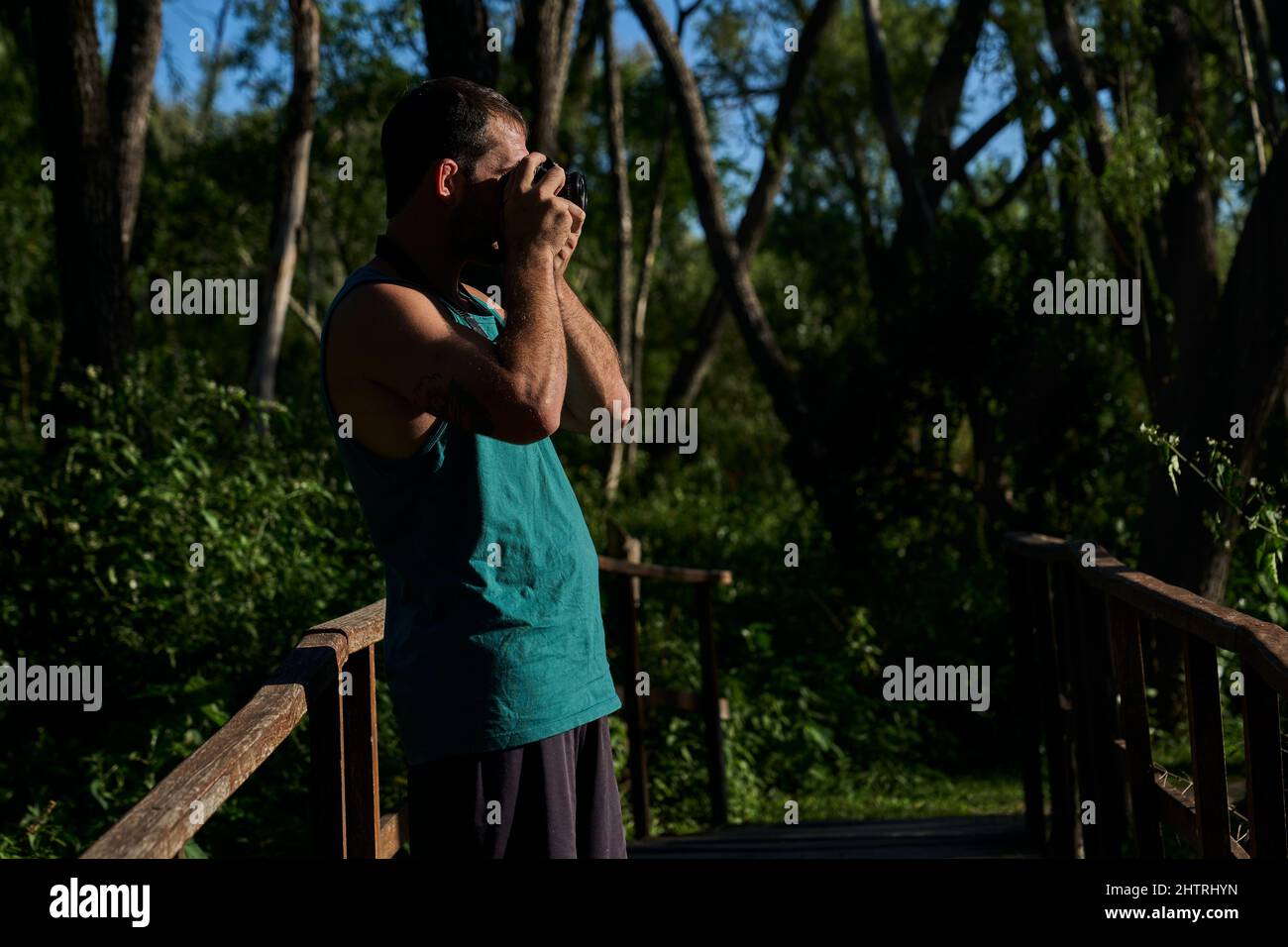 young man photographing in nature with vintage camera Stock Photo