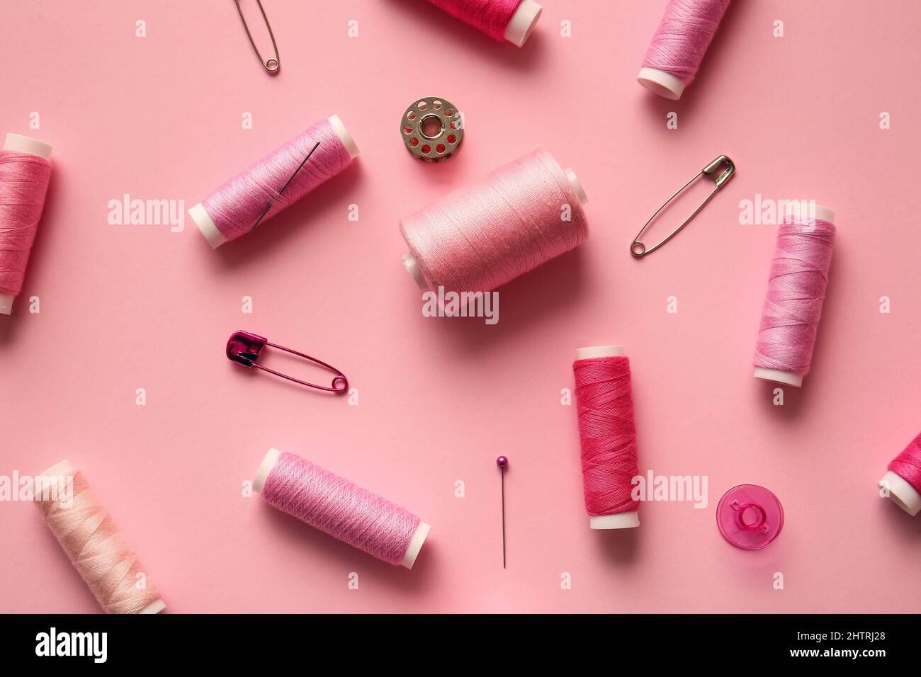 Composition with thread spools on color background Stock Photo