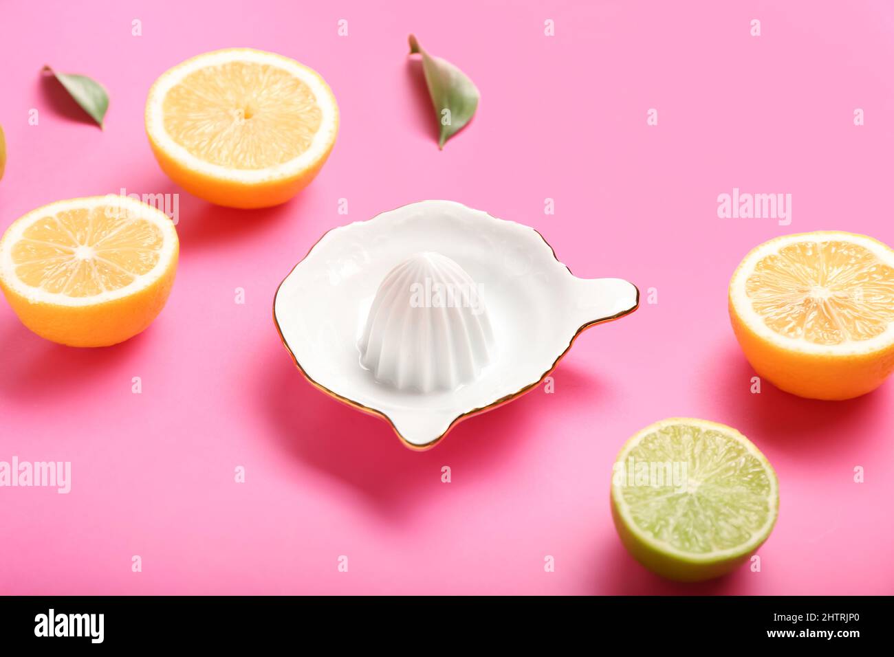 Ceramic juicer, cut lemons and limes on pink background Stock Photo Alamy