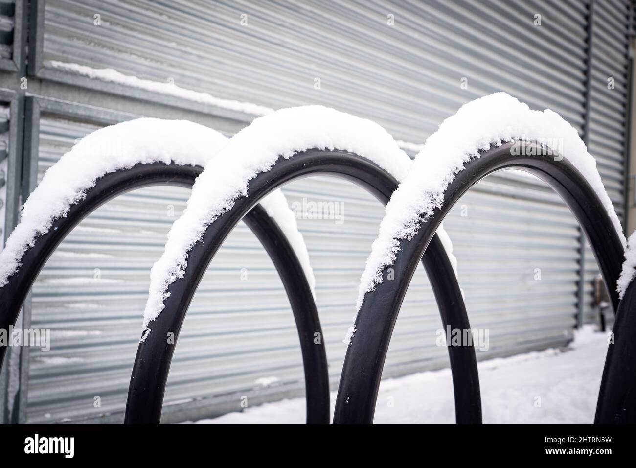 A modern bike rack covered in snow at a downtown work place in Calgary