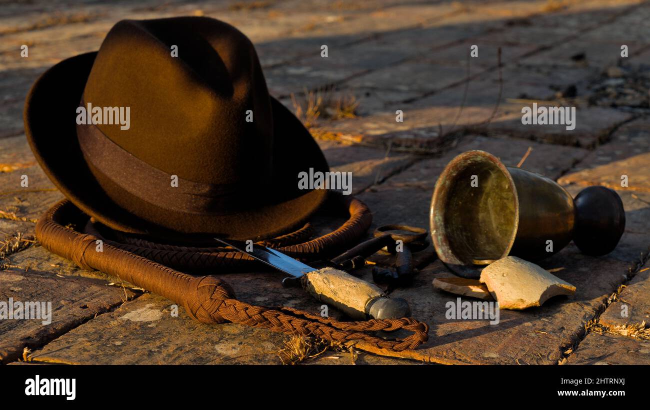Indiana Fedora hat, whip and antique artifacts Stock Photo
