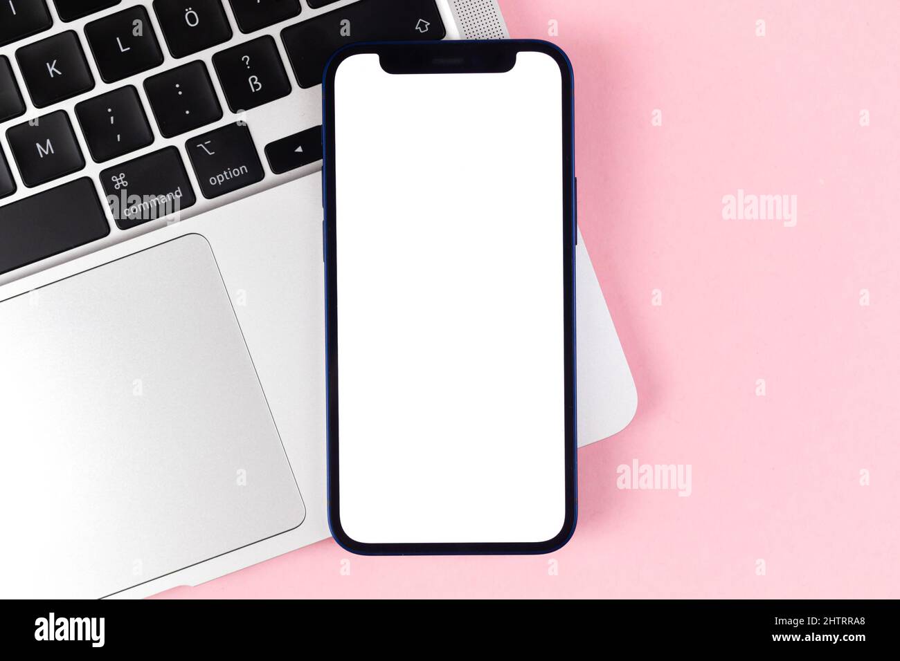 Flat lay Apple iPhone screen mockup, office desktop with laptop, bright pink background. Top view, copy space photo Stock Photo