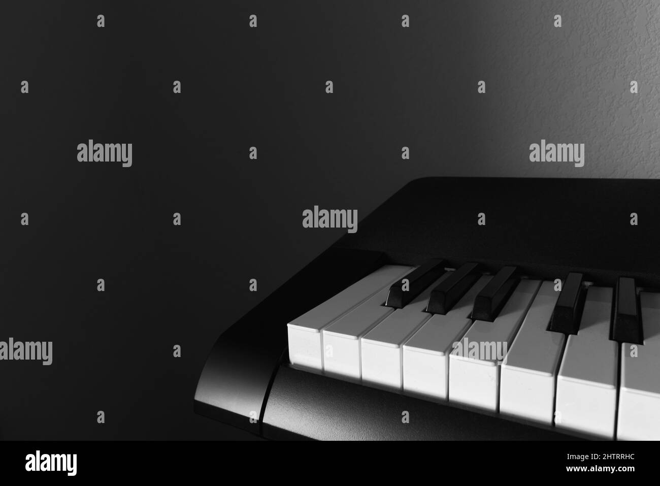 Close-up of Piano with Shadows in the Background Stock Photo