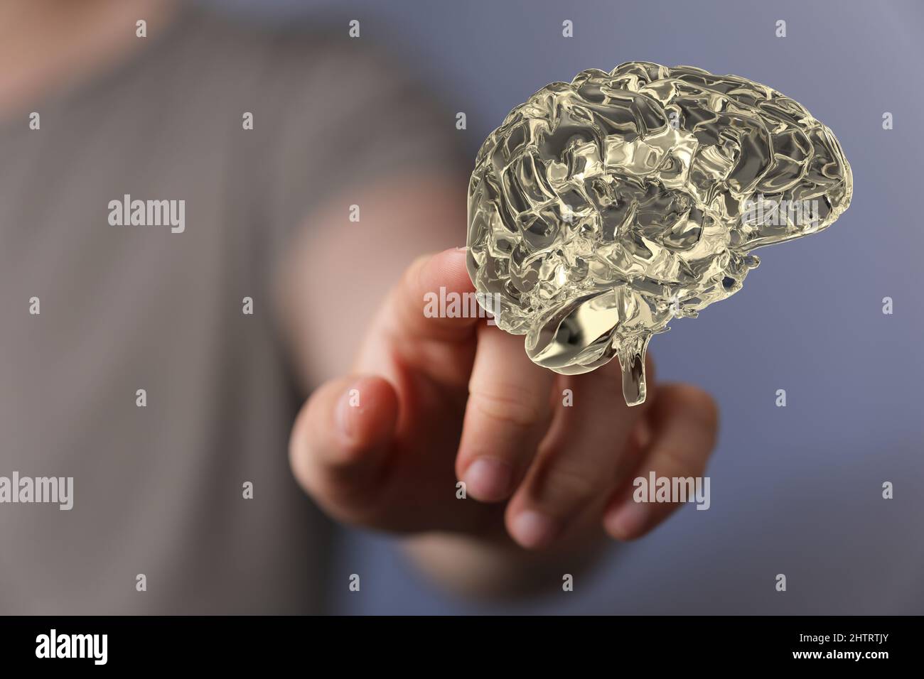 3D rendering of a gold color human brain floating in the air and a man ...