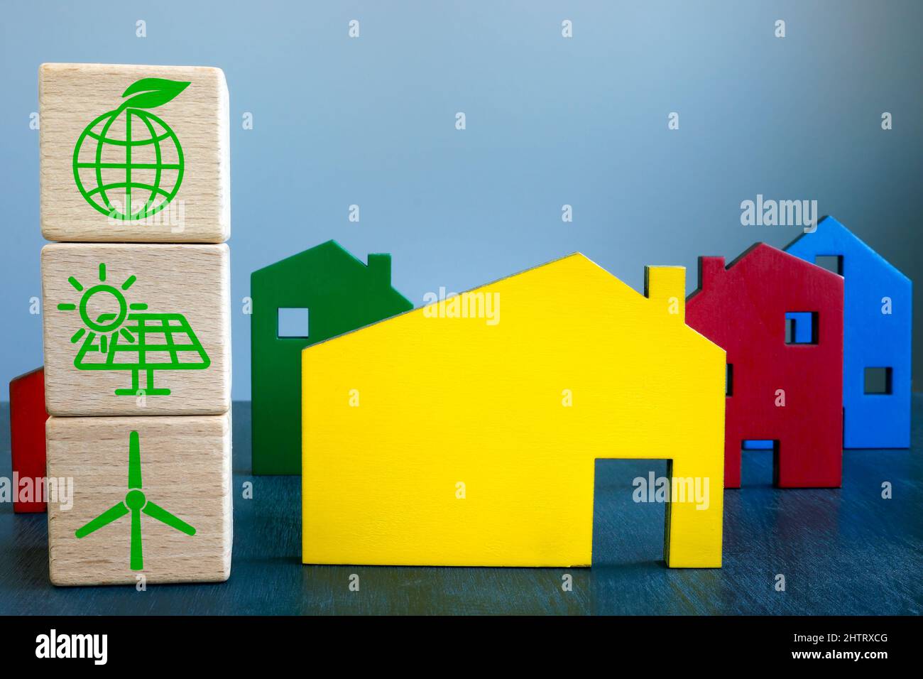 Sustainable renewable energy house concept. Cubes and wooden homes. Stock Photo