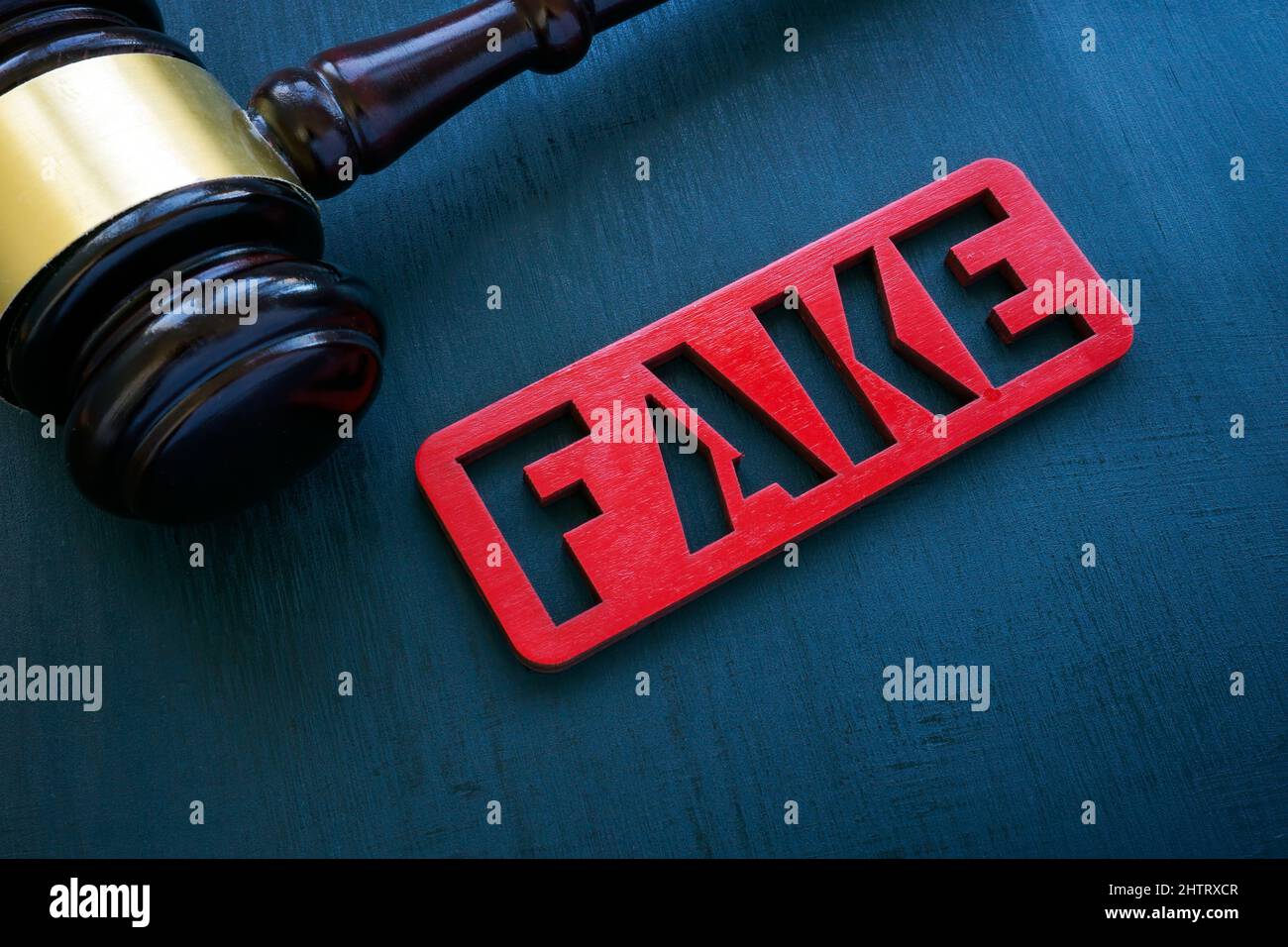 Fake news and punishment concept. Gavel and plate on the surface. Stock Photo