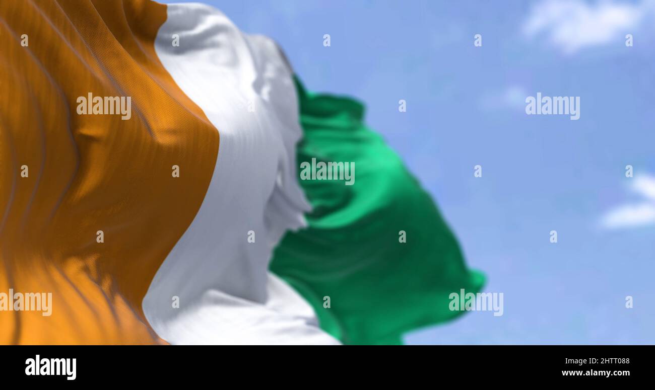 Detail of the national flag of Ivory Coast waving in the wind on a clear day. Ivory Coast is a country on the southern coast of West Africa. Selective Stock Photo