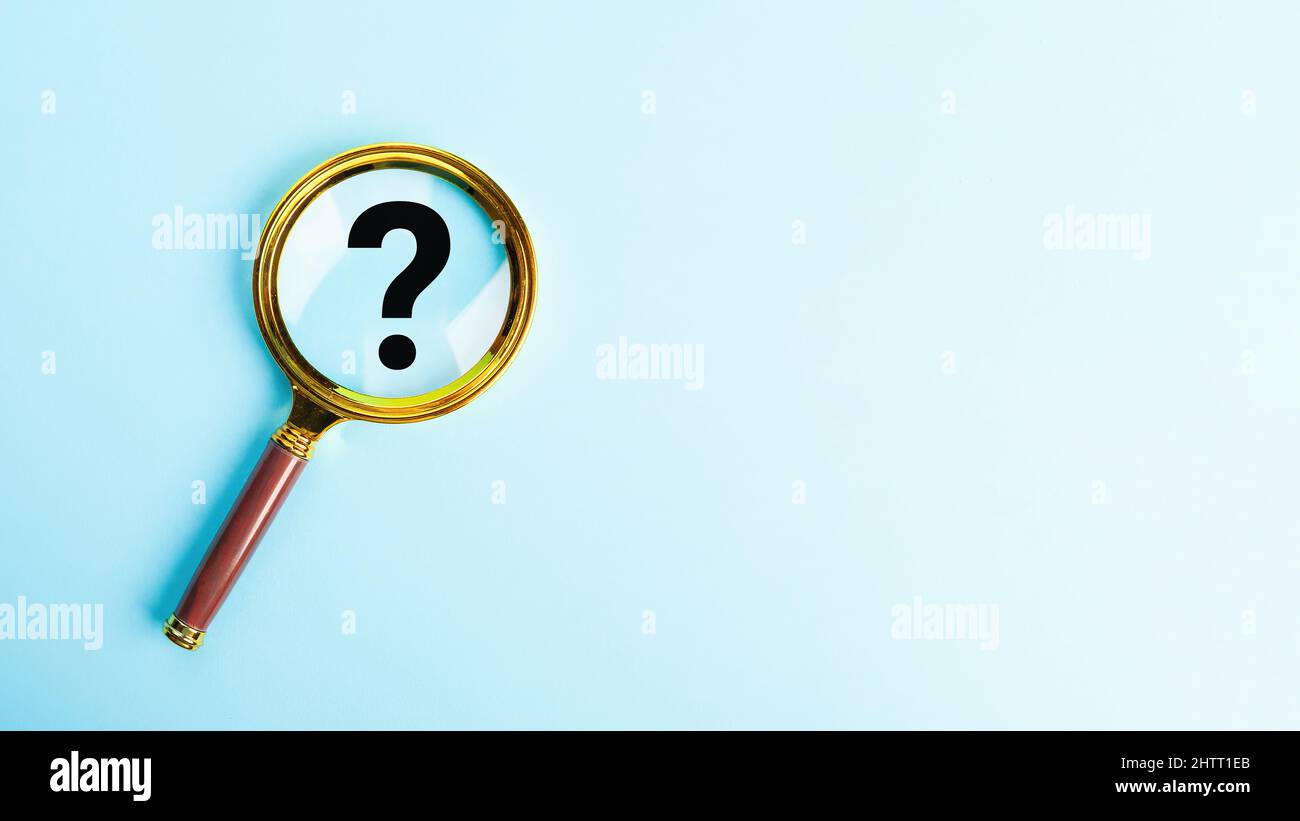 Magnifying glass with question mark symbol on blue background. T Stock