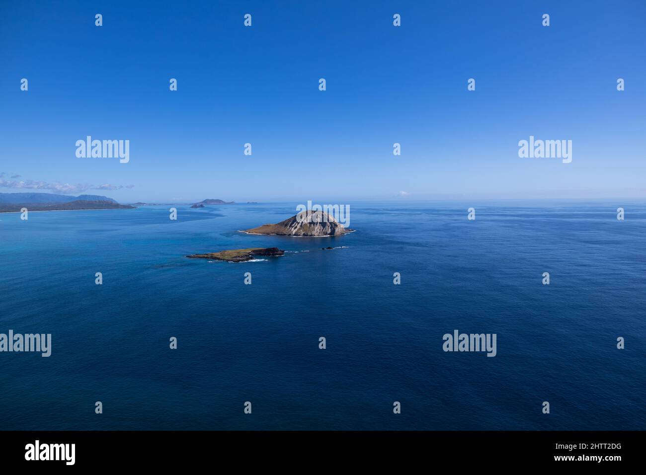 Small island in the blue ocean Stock Photo - Alamy