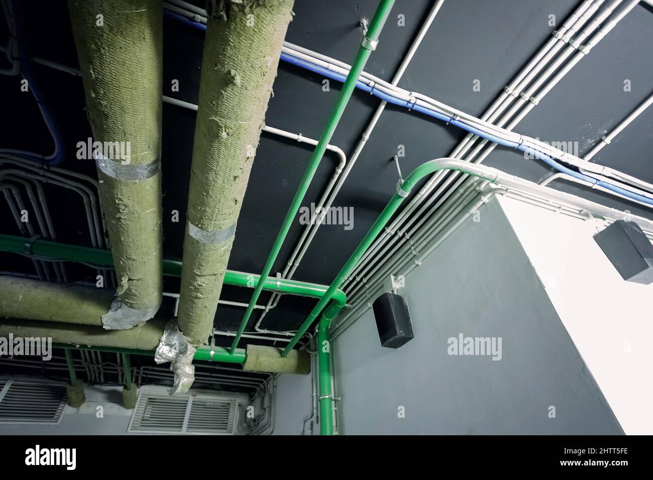 Laying of engineering networks. Ventilation pipes. Air conditioning in buildings. Pipe installation. Maintenance of cable networks. Abstract industria Stock Photo