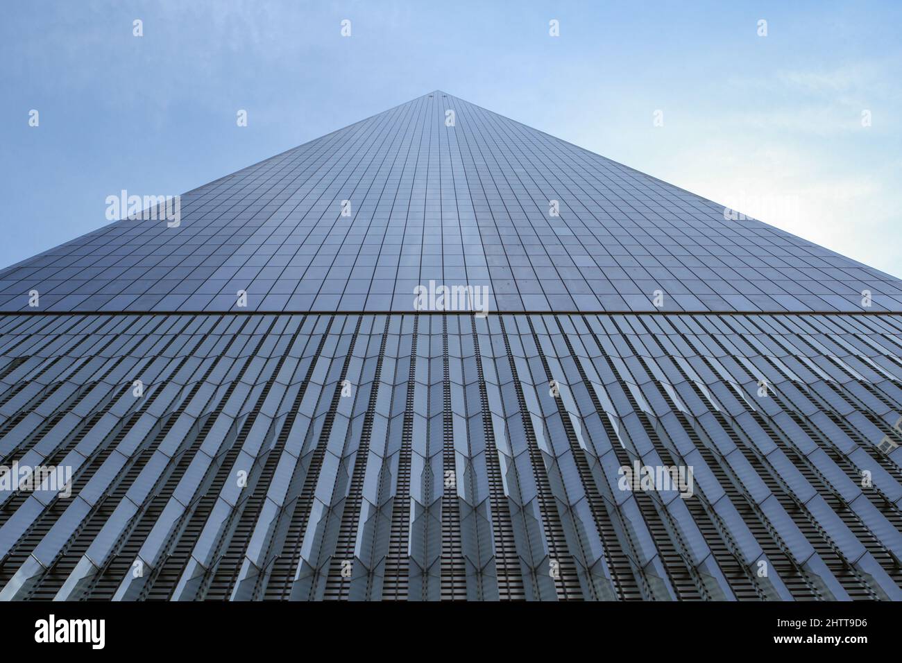 glass skyscraper shot from below pointing towards the blue sky different perspective Stock Photo