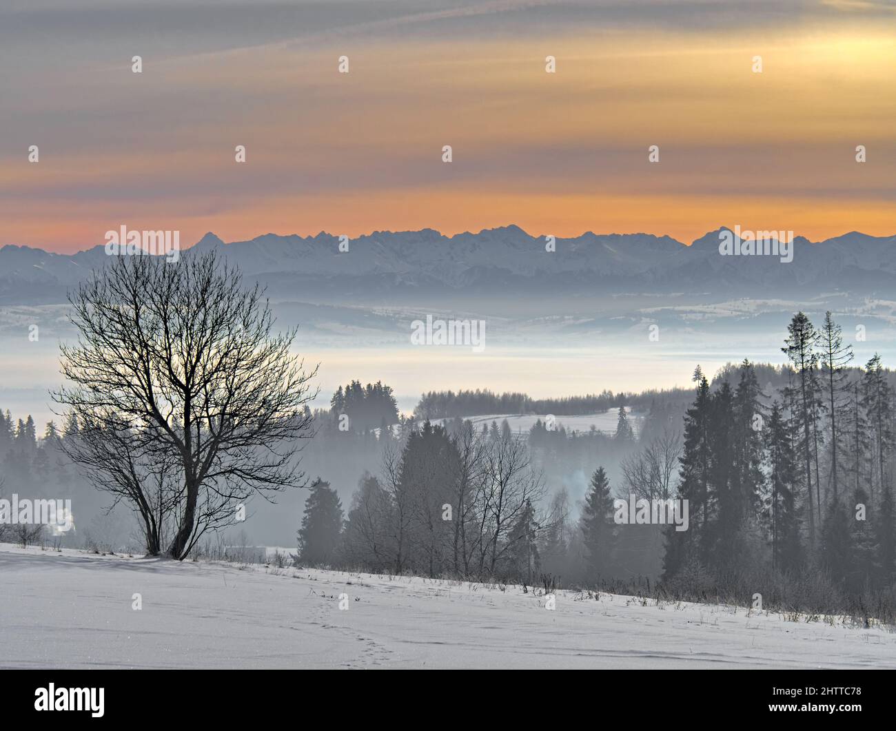 Mountains and a hazy valley in winter Stock Photo