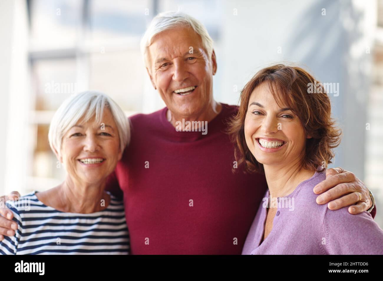 The most important women in my life. Portrait of a senior man standing beside his wife and daughter. Stock Photo