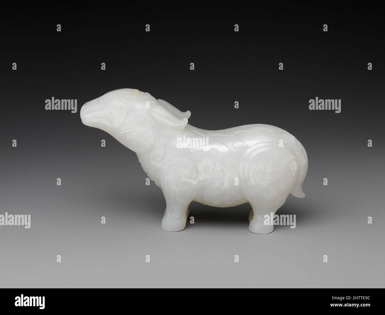 Art inspired by Fantastic animal, Qing dynasty (1644–1911), 18th century, China, Jade (nephrite), H. 2 in. (5.1 cm); W. 3 3/8 in. (8.6 cm), Jade, The form of this tapir-like animal and the abstract curvilinear patterns on its body can both be traced to vessels produced during China’s, Classic works modernized by Artotop with a splash of modernity. Shapes, color and value, eye-catching visual impact on art. Emotions through freedom of artworks in a contemporary way. A timeless message pursuing a wildly creative new direction. Artists turning to the digital medium and creating the Artotop NFT Stock Photo