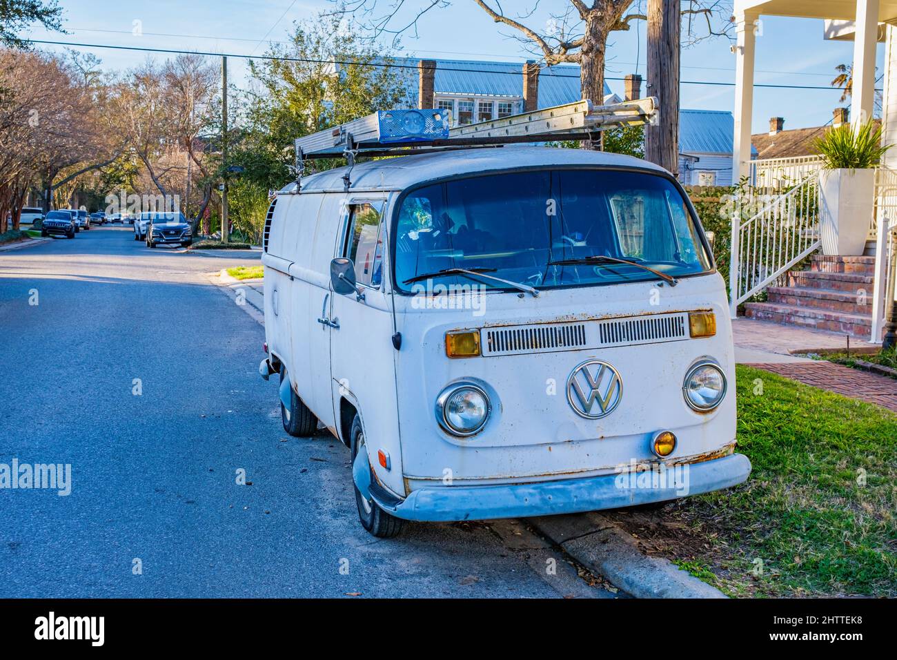 NEW ORLEANS, LA, USA - FEBRUARY 28, 2022: Working vintage Volkswagen Minivan with ladders on top parked in Uptown neighborhood Stock Photo