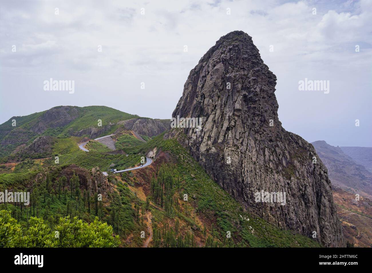Panoramic view of Roque de Agando from a viewpoint near Vallehermoso (La Gomera, Canary islands, Spain) with the Garajonay National Park in the backgr Stock Photo