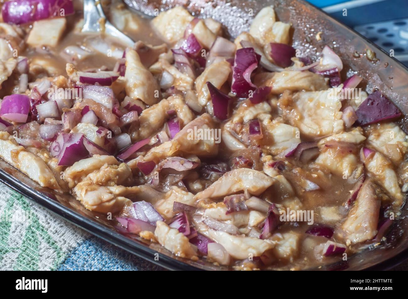 Tilapia sashimi with red onion, lemon and ginger, mixed with sliced tilapia fillet. Stock Photo