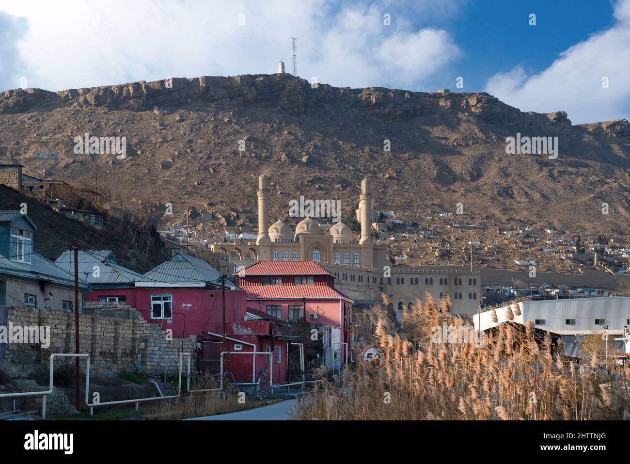 Baku, Azerbaijan - January 09 2022-Bibi Heybat Mosque with rocky hill and cloudy sky in the background Stock Photo