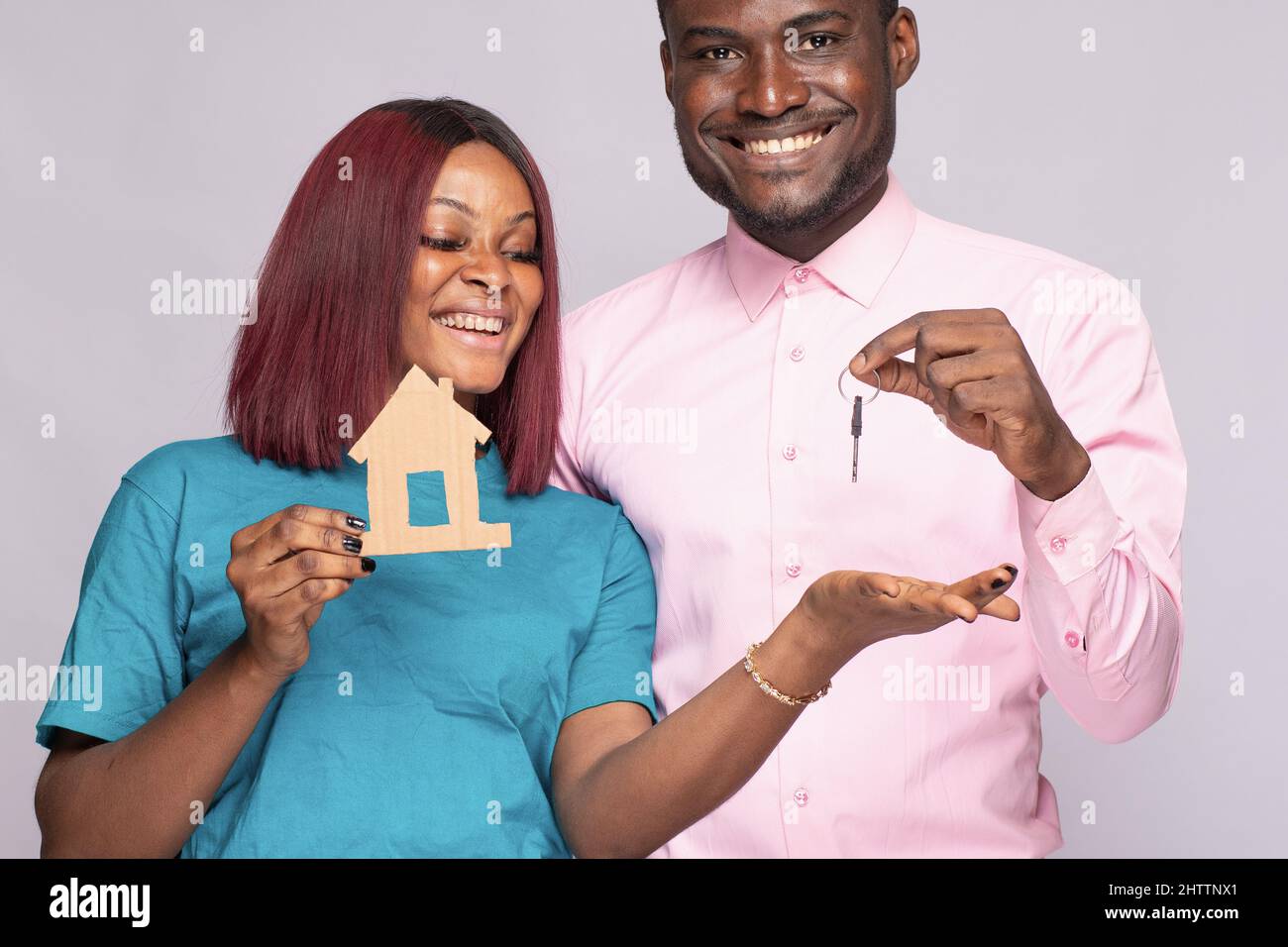 Happy African couple holding a smal wooden house together. Family ...