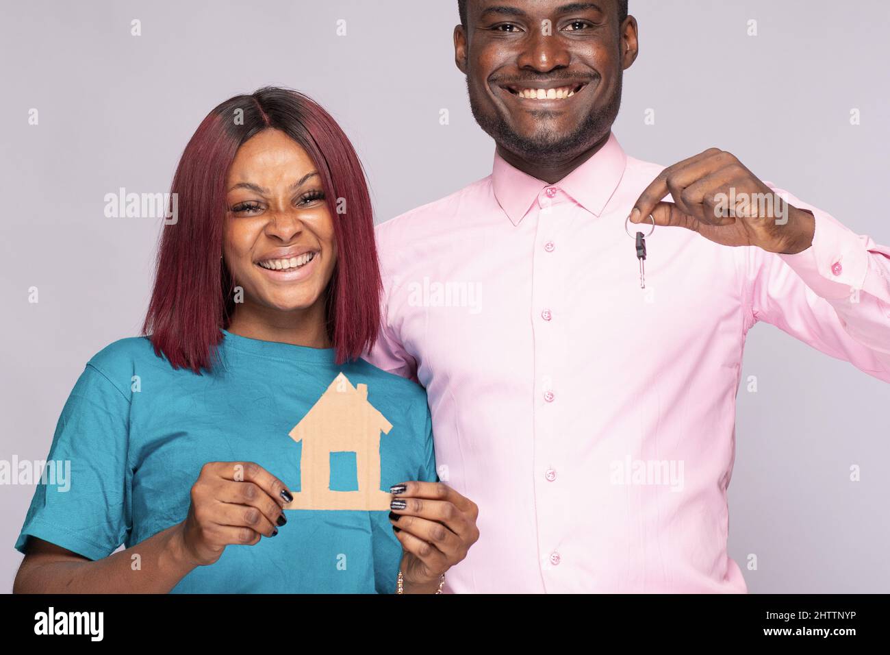 Happy African couple holding a smal wooden house together. Family ...