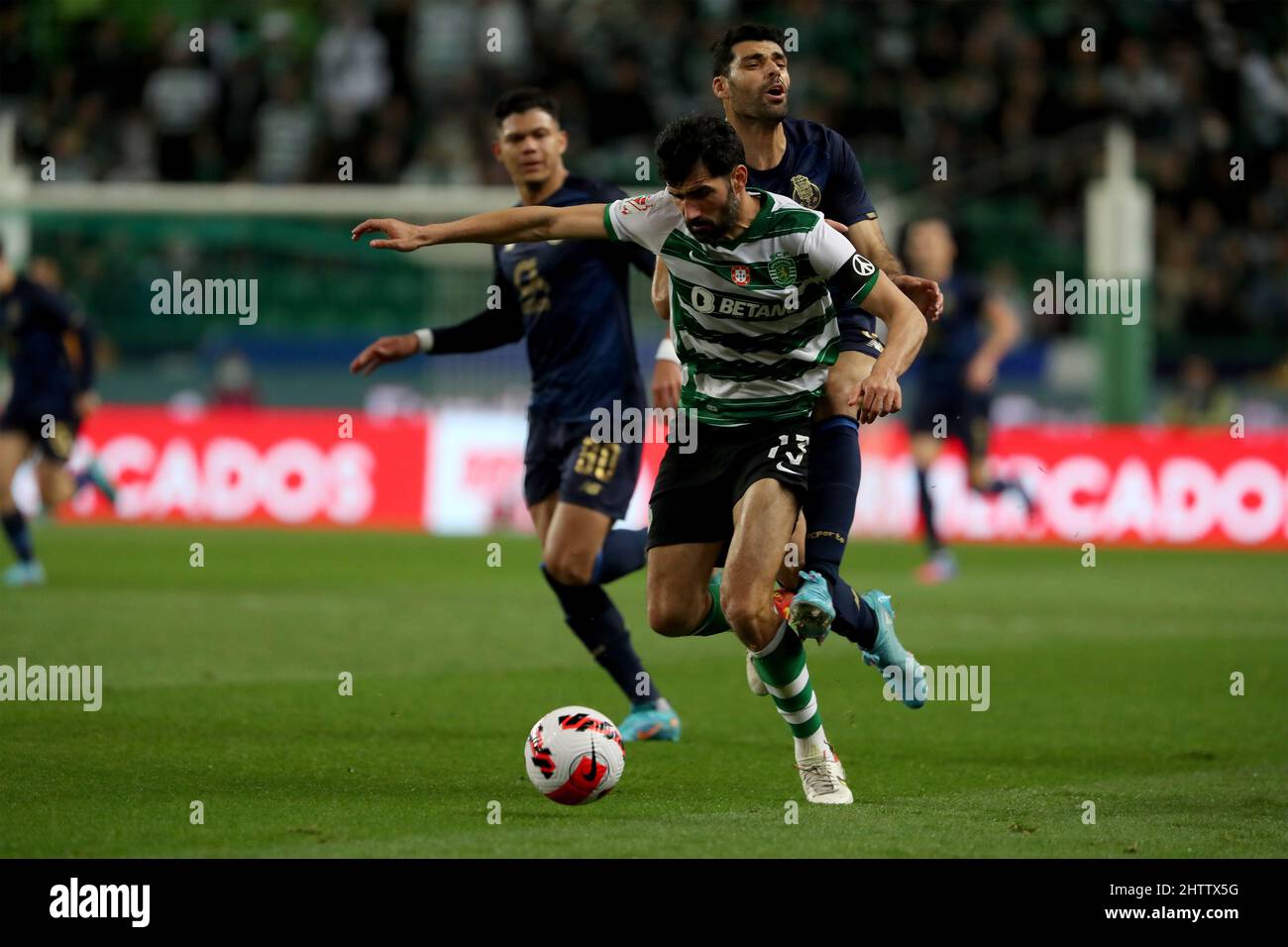Lisbon, Portugal. 2nd Mar, 2022. Luis Neto of Sporting CP (L) fights for the ball with Mehdi Taremi of FC Porto during the Portugal Cup semi-final first leg football match between Sporting CP and FC Porto at the Jose Alvalade stadium in Lisbon, Portugal on March 2, 2022. (Credit Image: © Pedro Fiuza/ZUMA Press Wire) Stock Photo