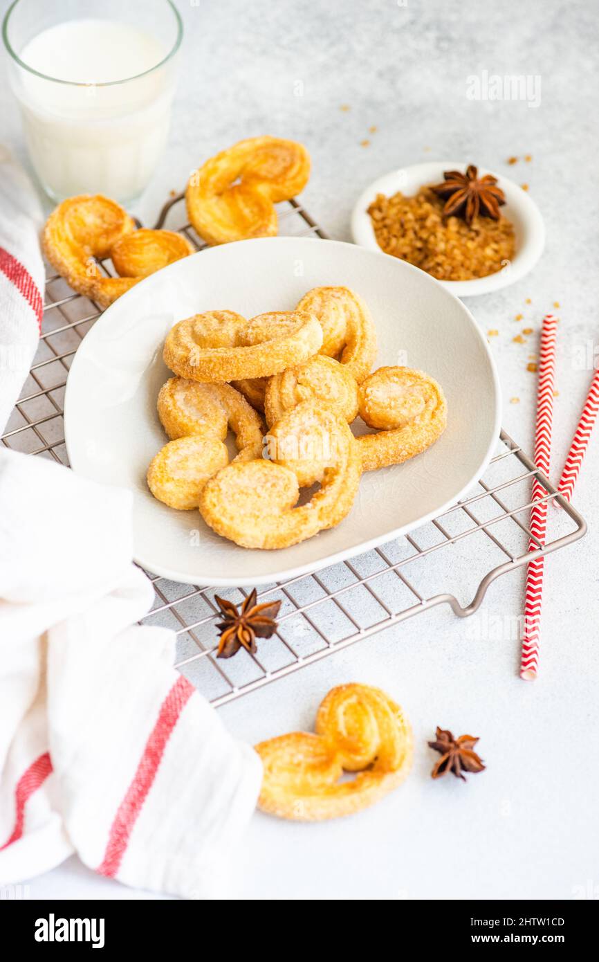 Traditional Puff pastry spiral biscuits known as a pig's ears on plate