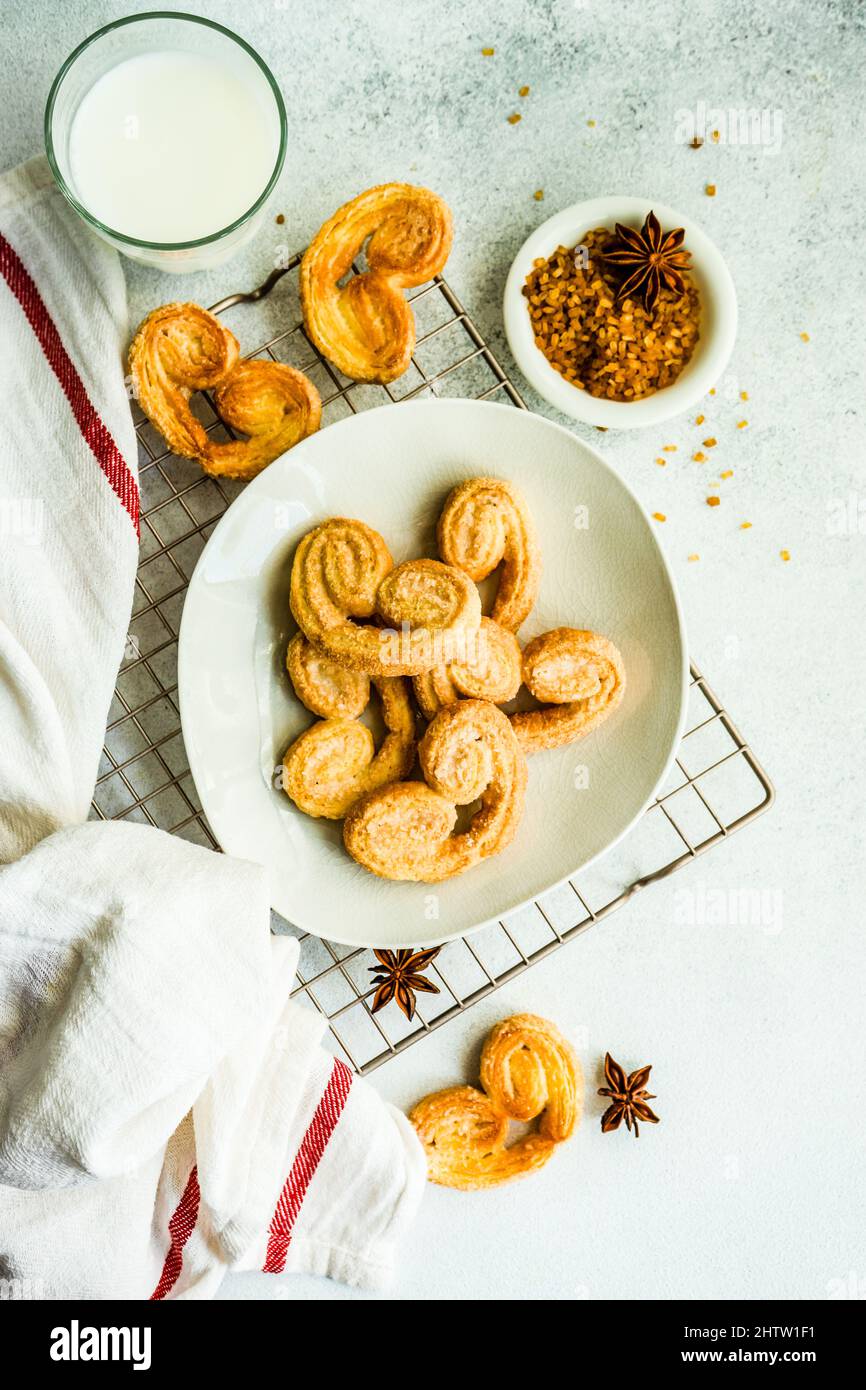 Traditional Puff pastry spiral biscuits known as a pig's ears on plate
