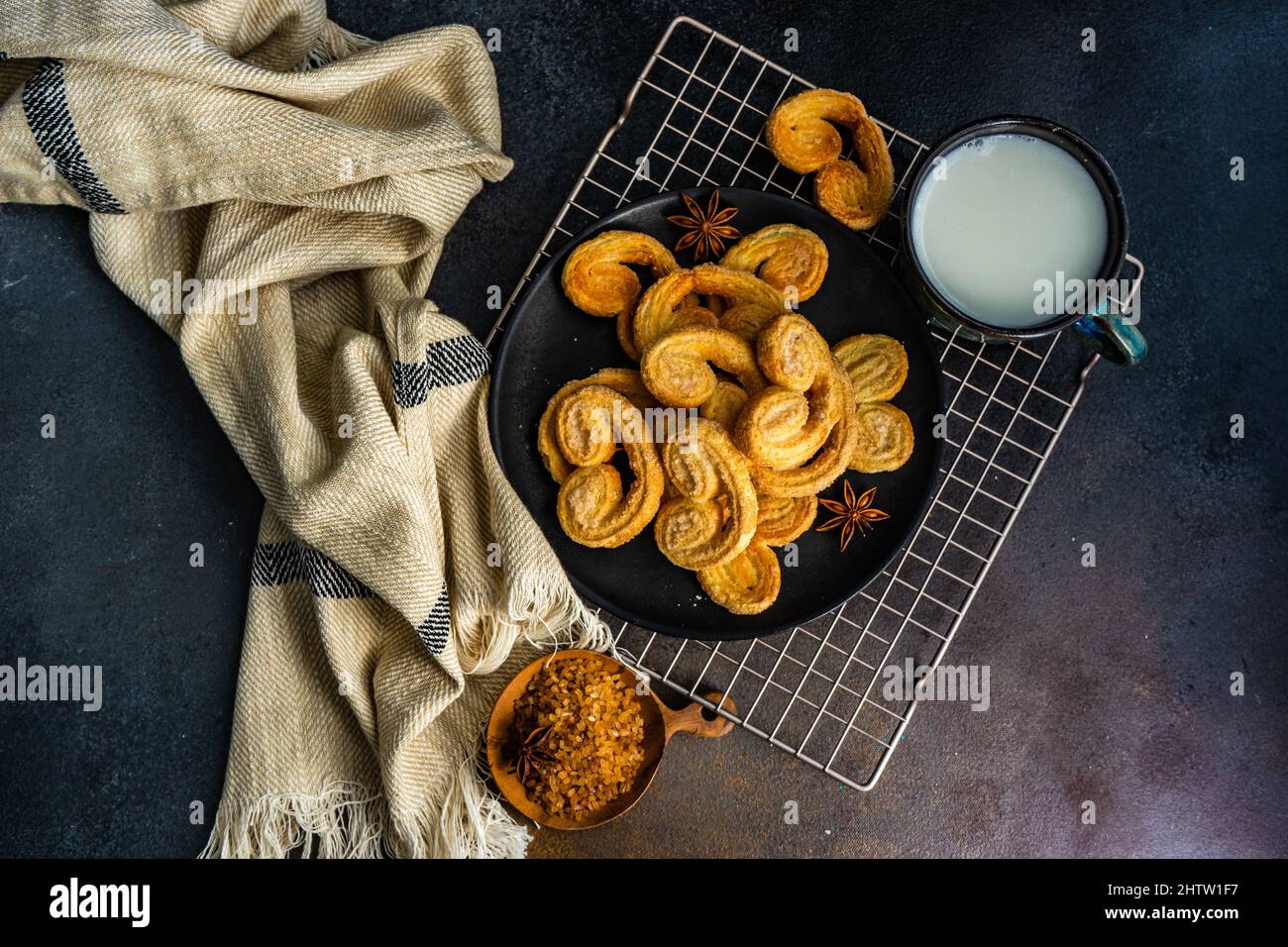 Traditional Puff pastry spiral biscuits known as a pig's ears on plate