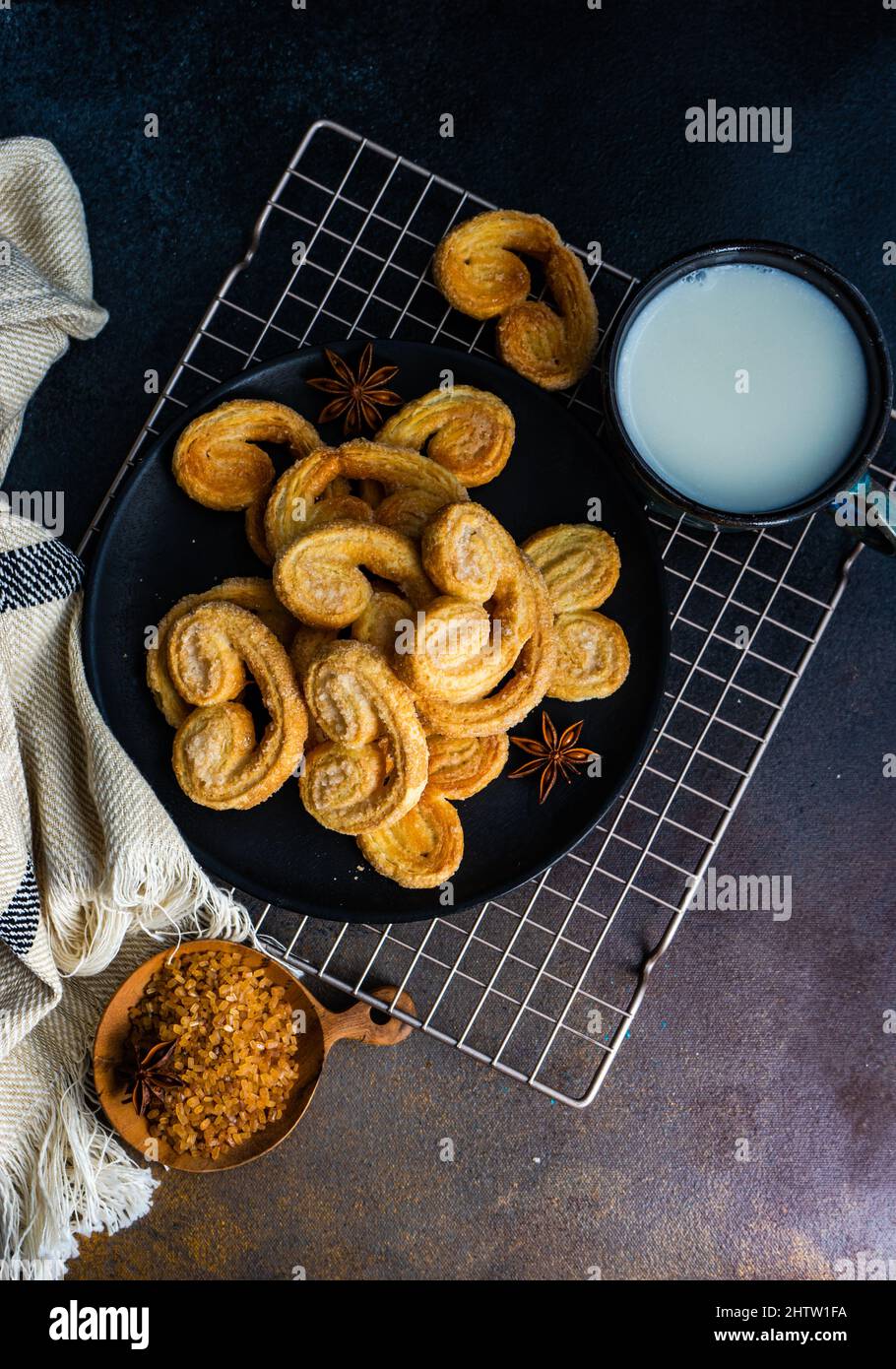 Traditional Puff pastry spiral biscuits known as a pig's ears on plate