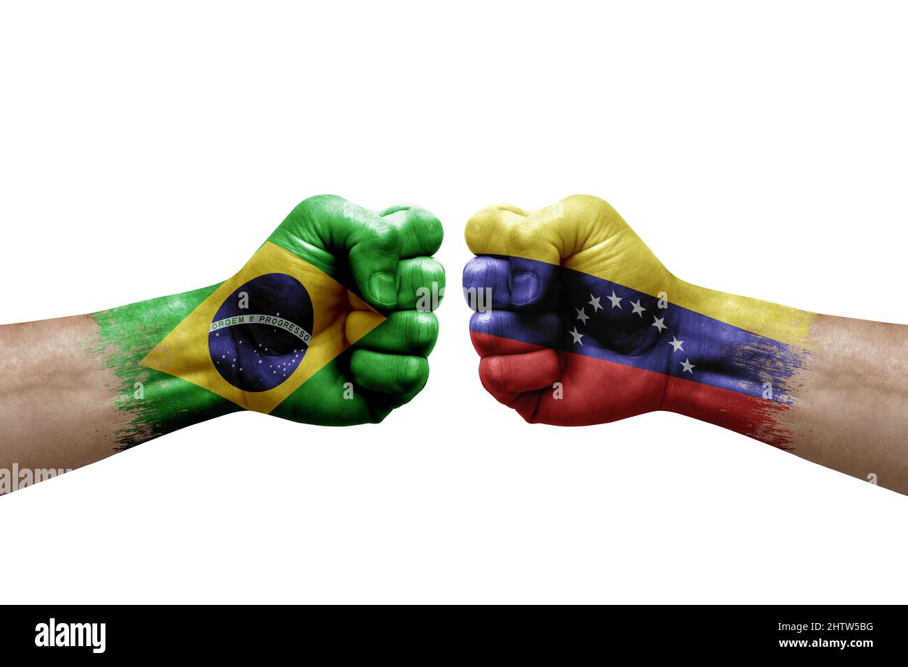 Two hands punch to each others on white background. Country flags painted fists, conflict crisis concept between brazil and venezuela Stock Photo