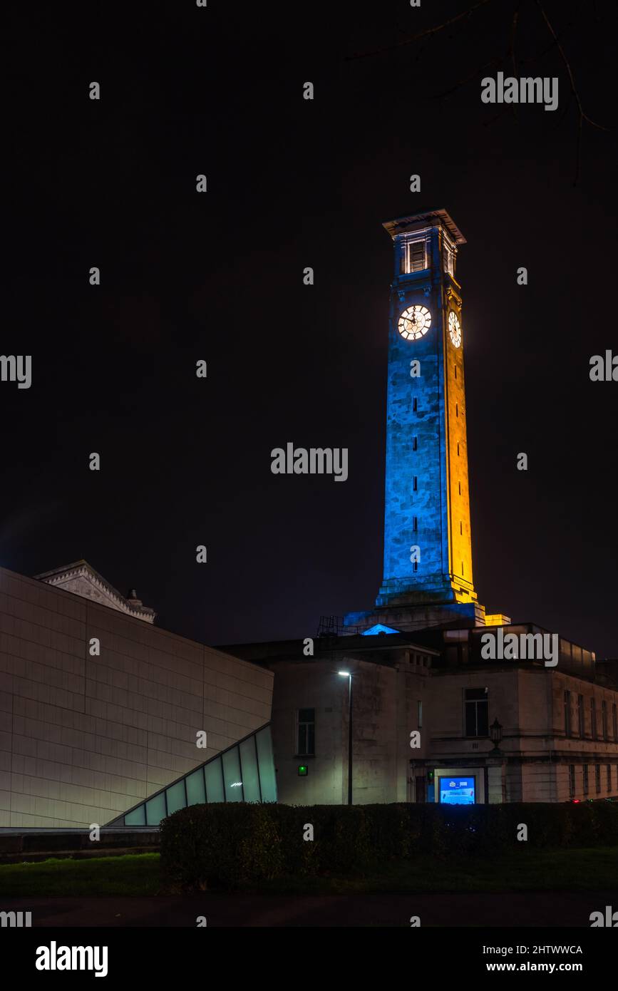 Southampton, UK. 3 March 2022. Southampton Guildhall and Civic Clock Tower at night illuminated in Blue and Yellow to stand in solidarity with Ukraine during the Russia Ukraine War 2022 Stock Photo