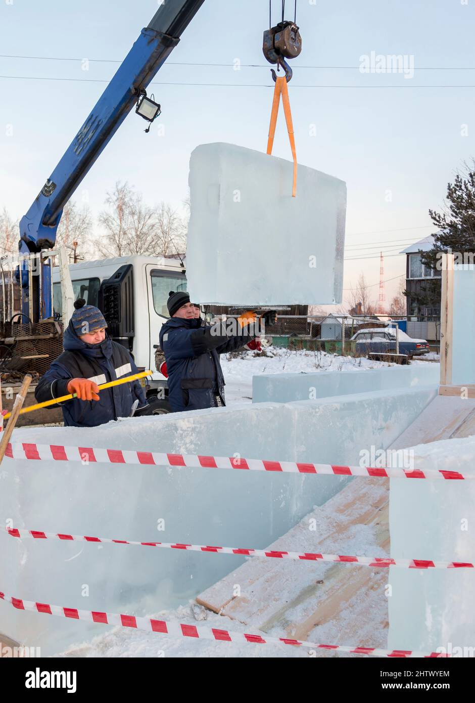Installers adjust and install another ice block to the overall ...