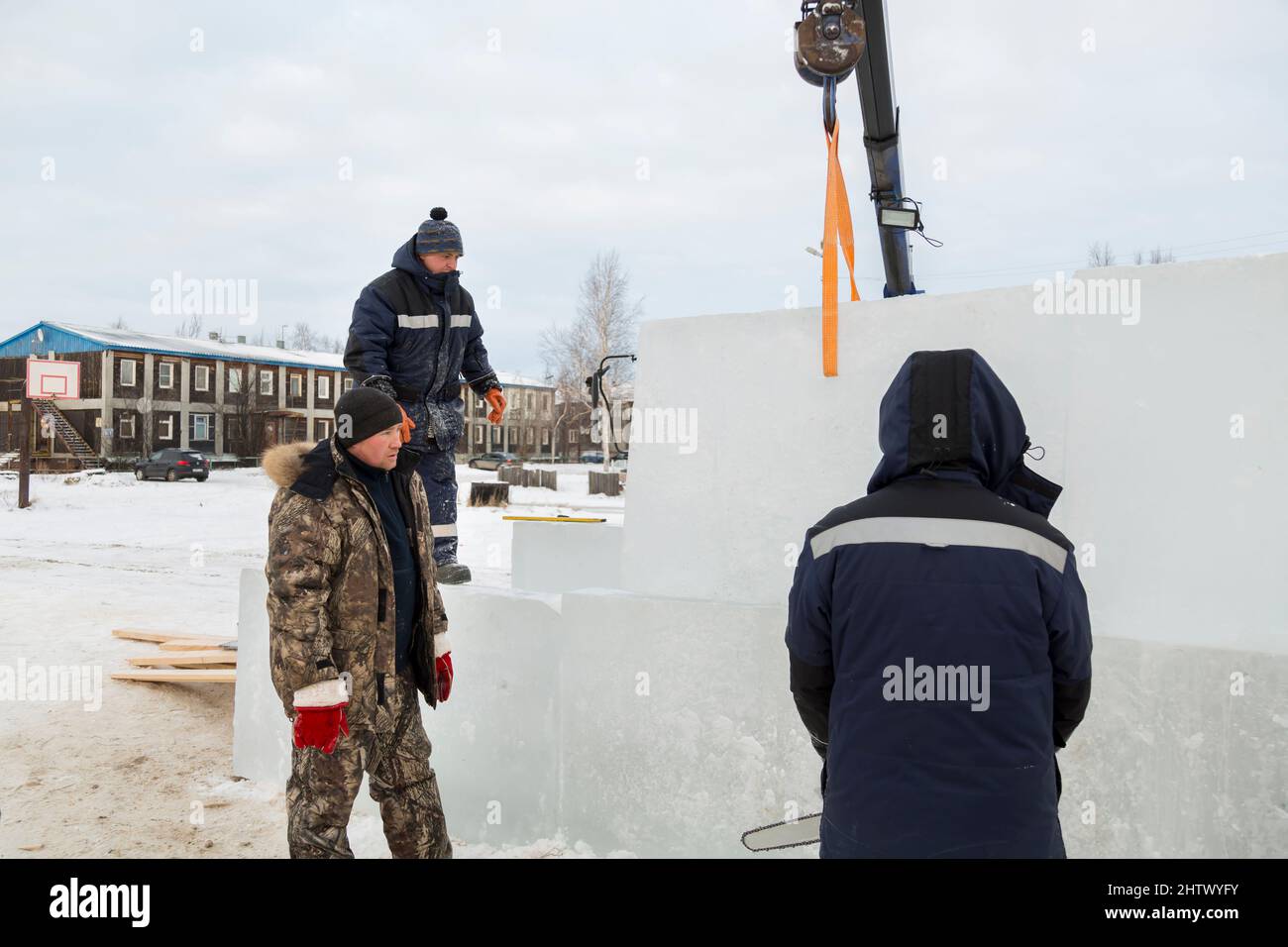 Installers adjust and install another ice block to the overall ...