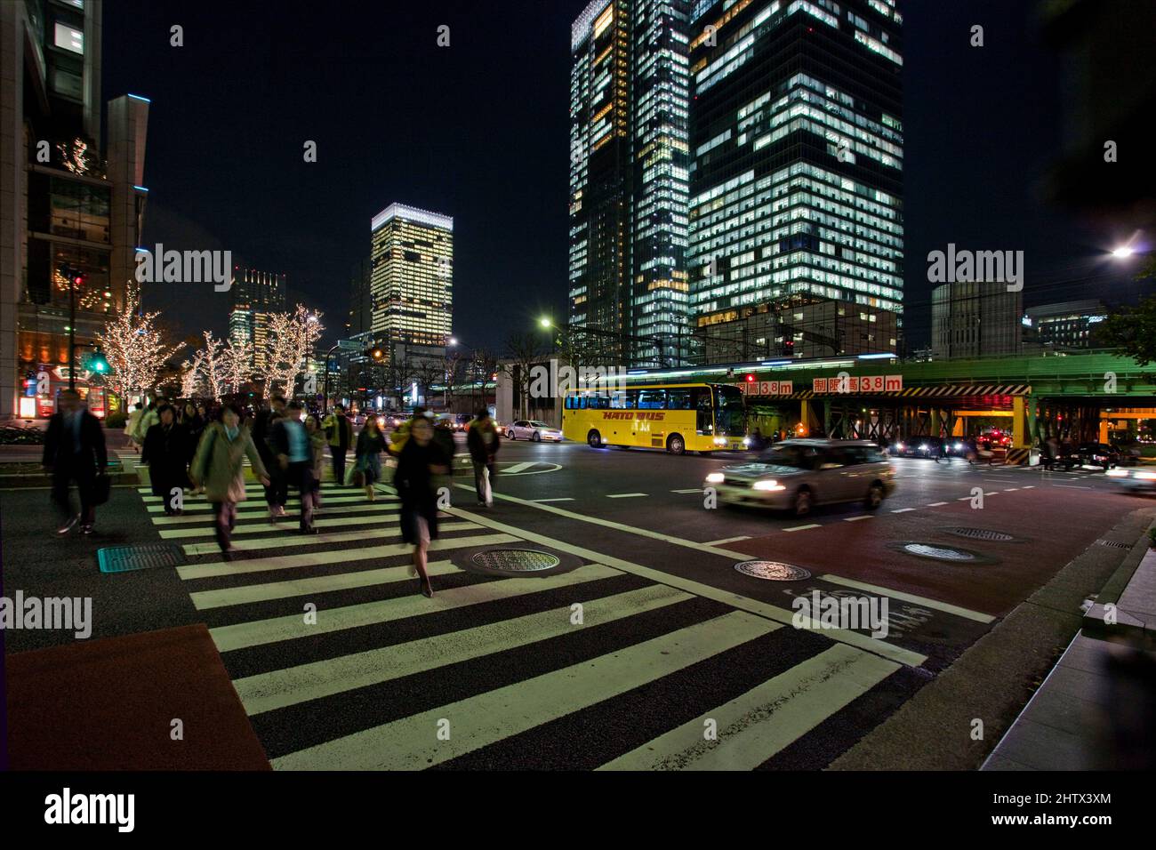 Blur of traffic and passing train evening MarunouchiTokyo Japan 2 Stock Photo