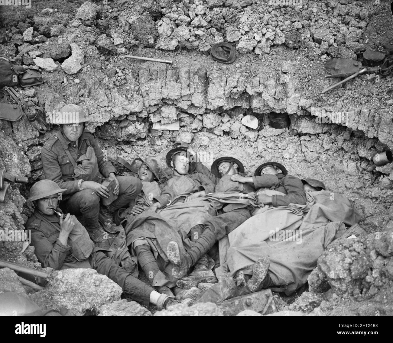 Troops of the Duke of Wellington's (West Riding) Regiment resting in a shell-hole after the capture of Marfaux on 23 July 1918. Stock Photo