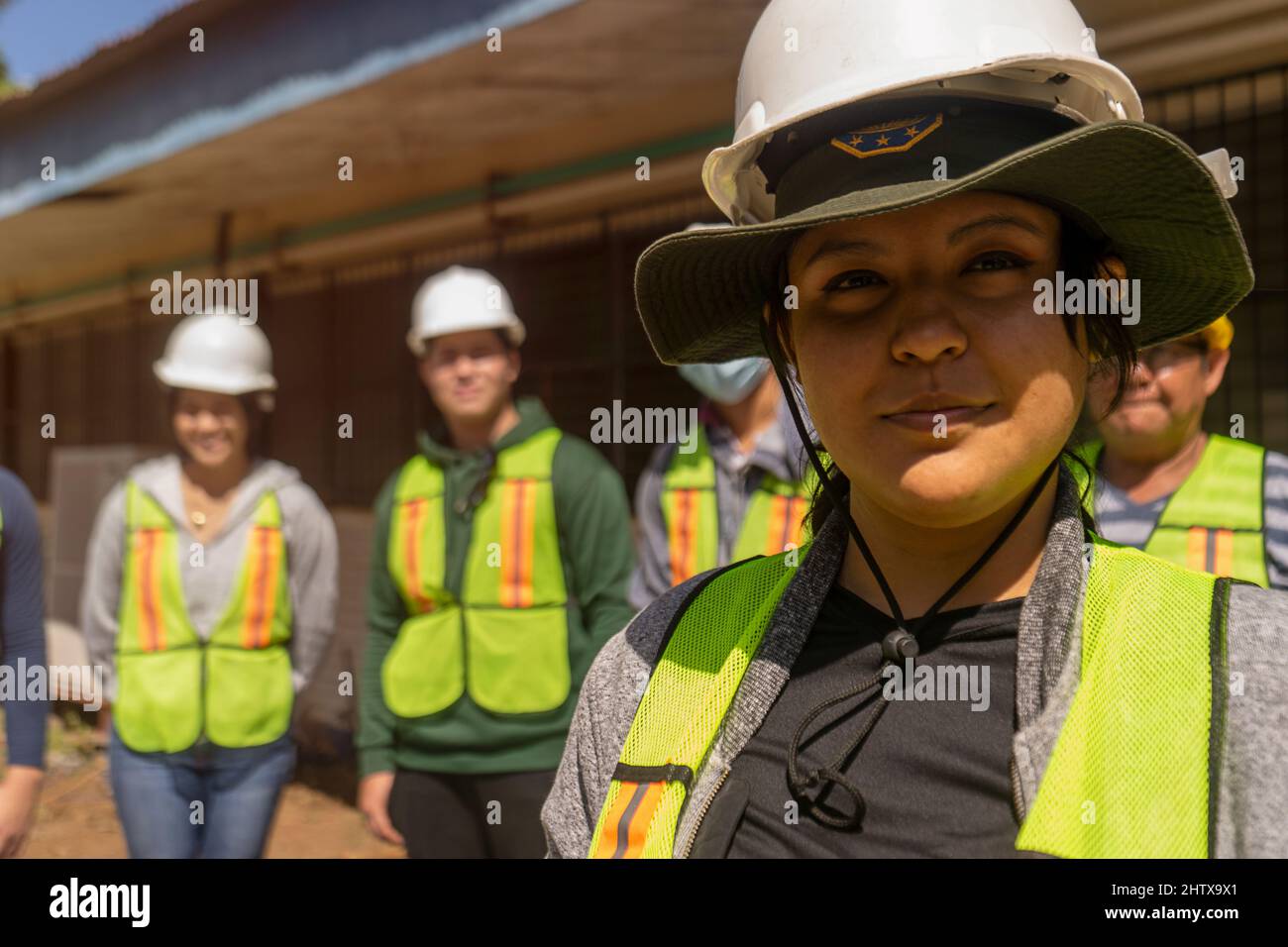 Empowered young woman, engineering student in front of a group of students and professionals Stock Photo