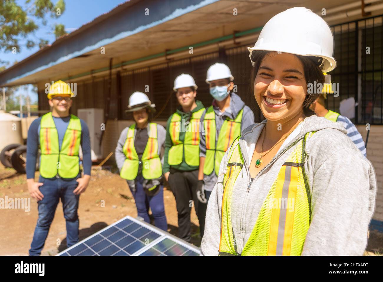 Empowered young woman, engineering student in front of a group of students and professionals Stock Photo