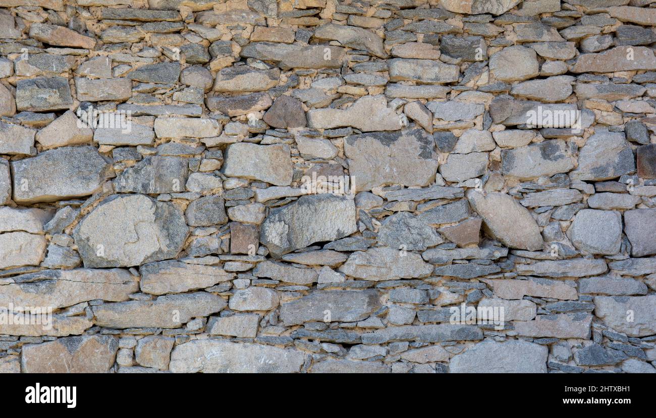 Old antique stone wall texture. Rocky Structure Backdrop. Background. Stock Photo