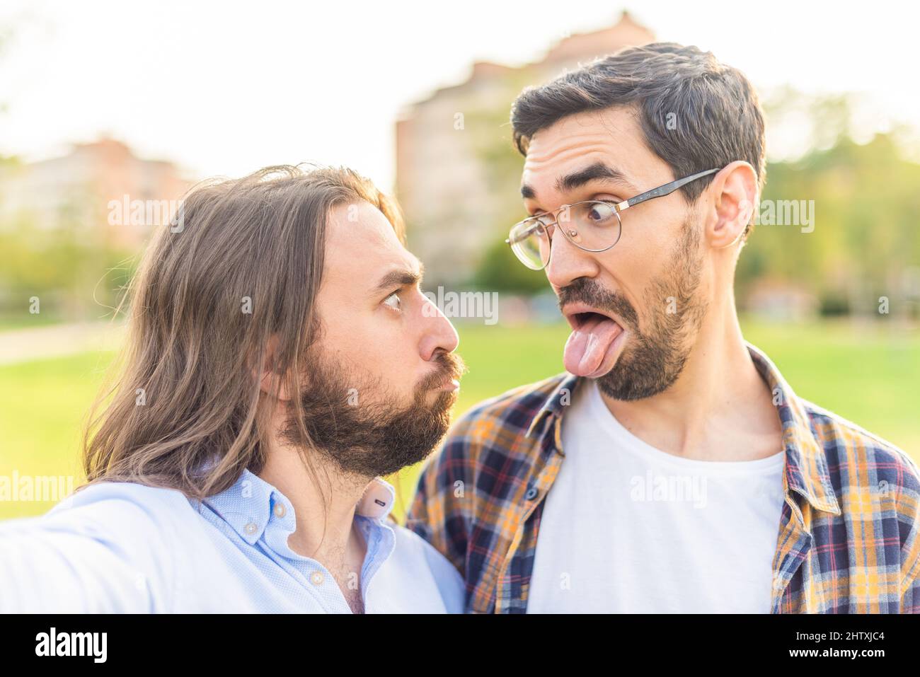 Funny Gay Couple Looking At Each Other And Making Grimaces Stock Photo Funny Gay Couple Looking At Each Other And Making Grimaces Stock Photo
