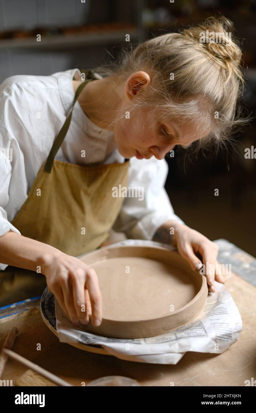Girl make clay plate in ceramic Stock Photo Alamy