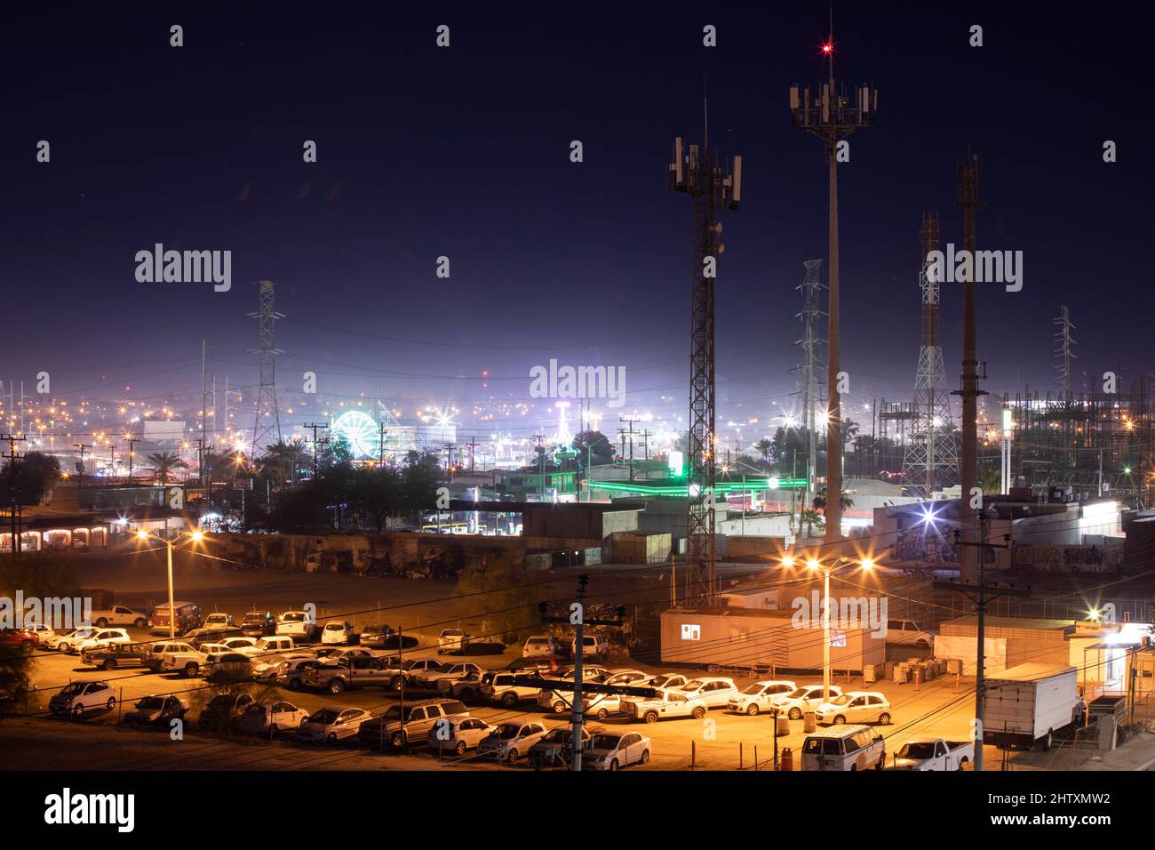 Mexicali, Baja California, Mexico - January 2, 2021: Night lights shine on communications towers in downtown Mexicali. Stock Photo