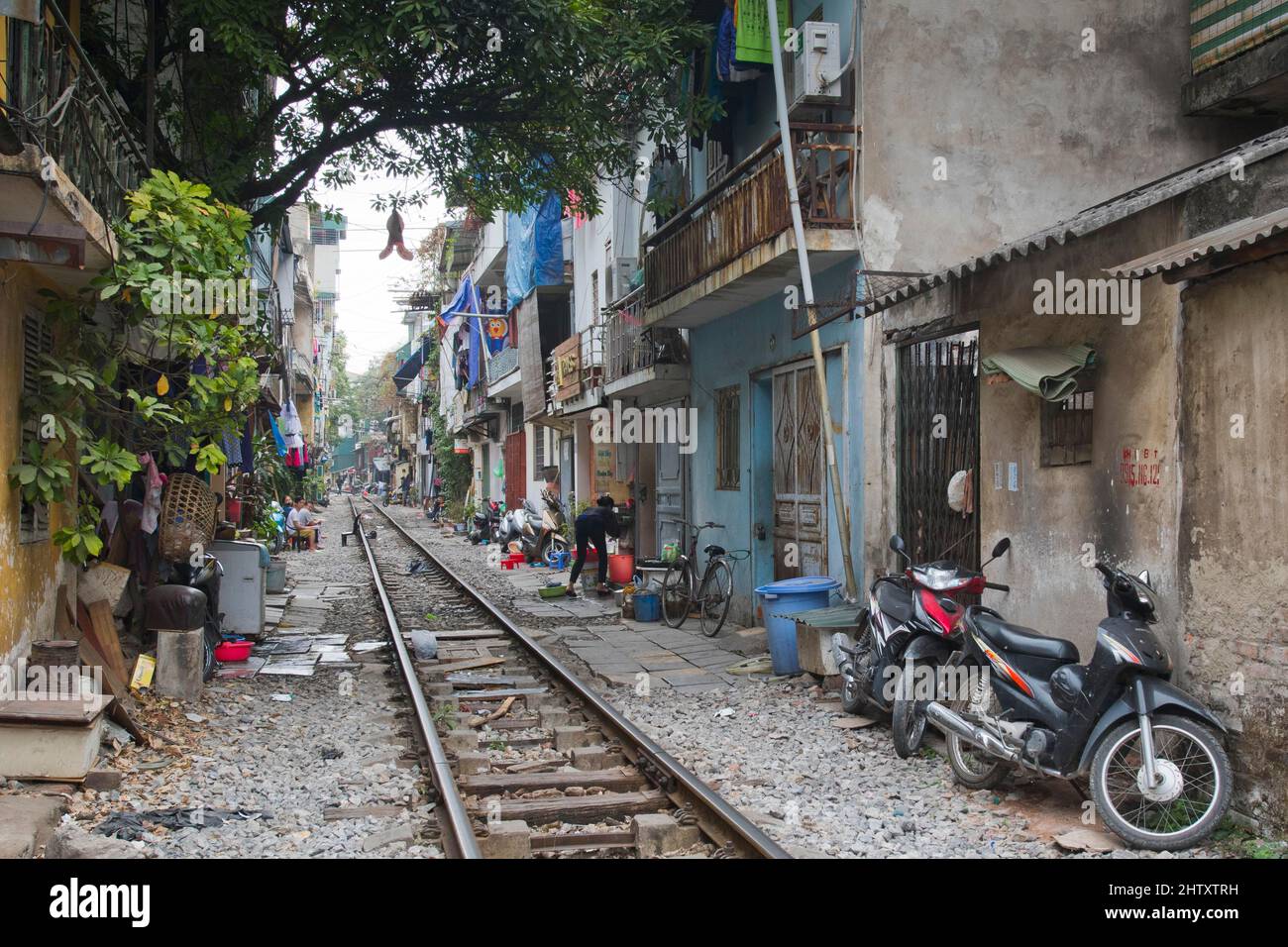 Railway line between houses, Hanoi, Vietnam Stock Photo