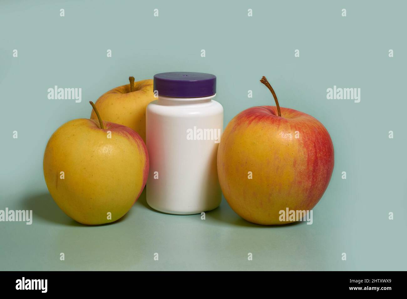 Mock up. A white plastic jar with a purple lid apples on a blue