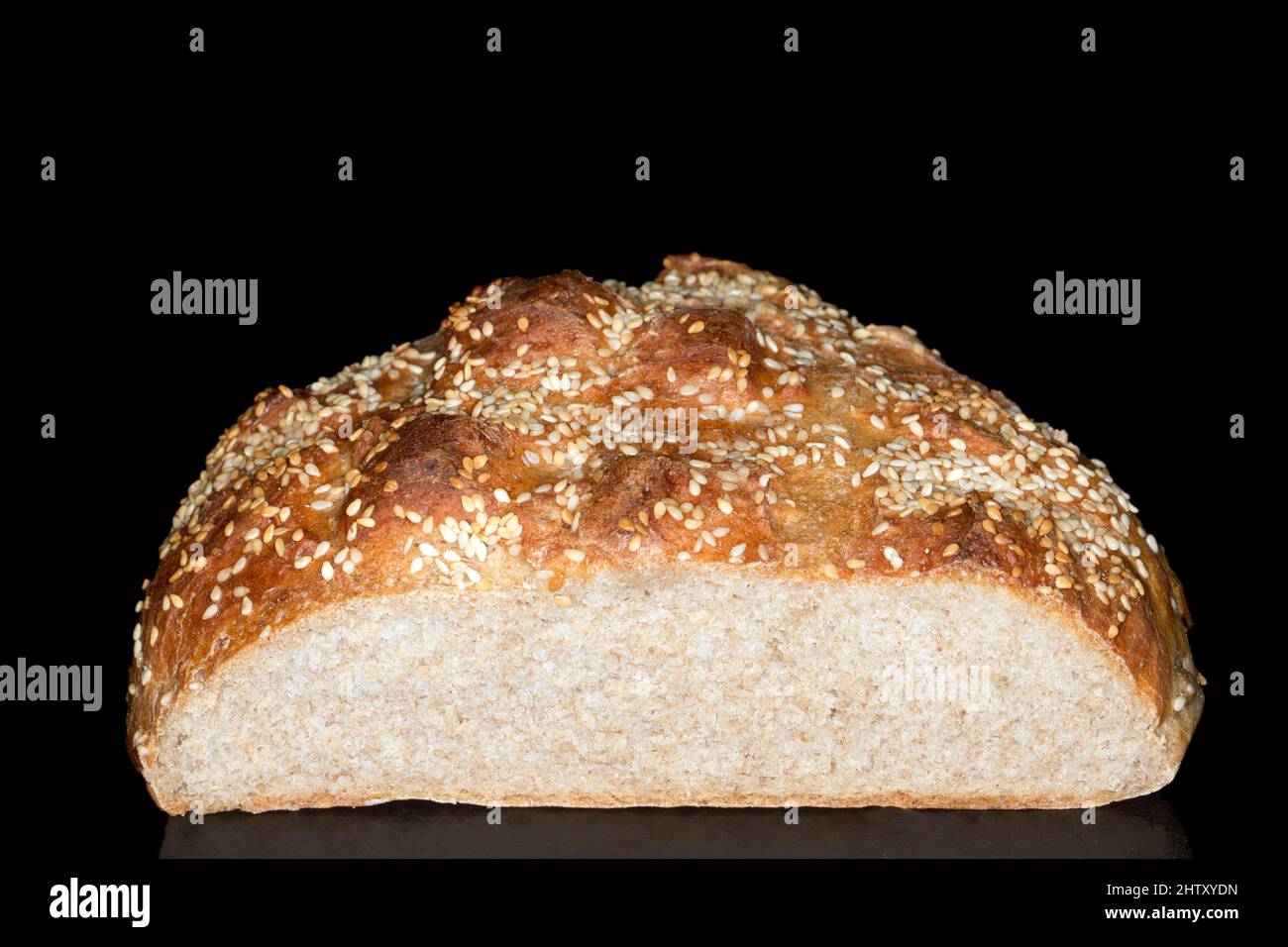 Cut bread with sesame seeds, studio photography with black background Stock Photo