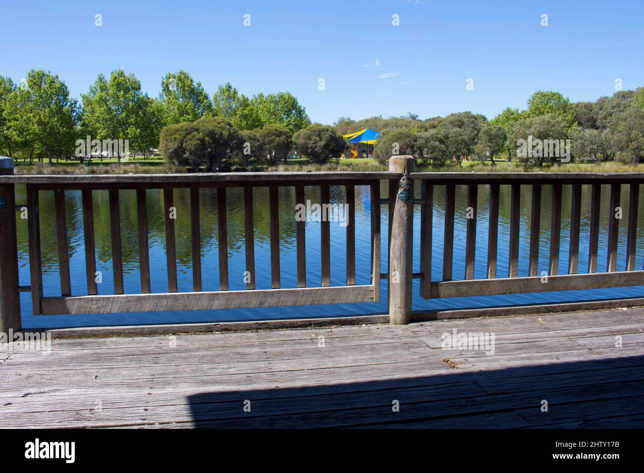 Scenic view of the boardwalk at Dalyellup, Western Australia on a cloudy late spring afternoon surrounded by water birds and paperbark melaleuca trees. Stock Photo