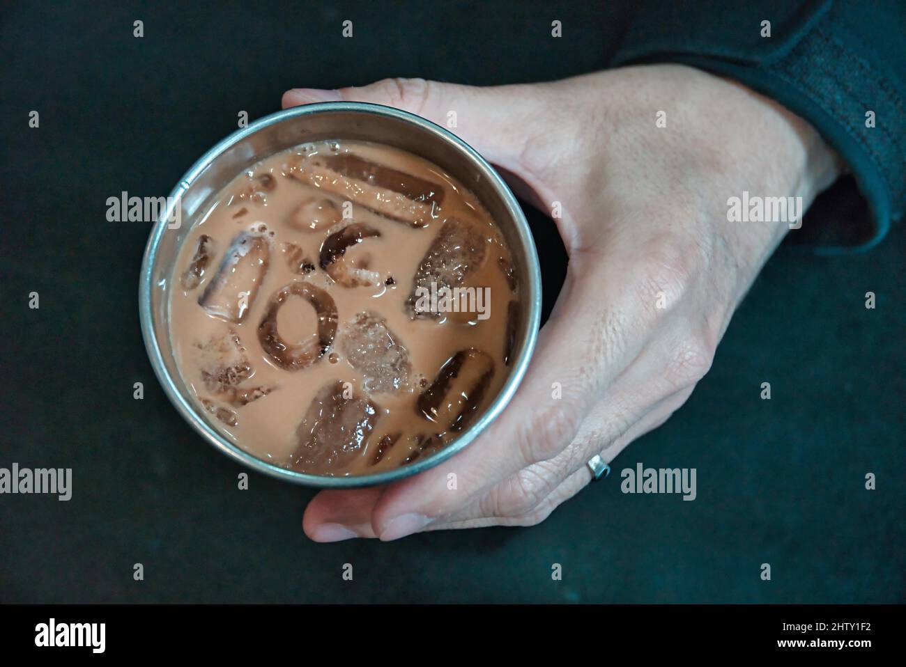Hand holding a cup of coffee, caffeine, mild tea Stock Photo