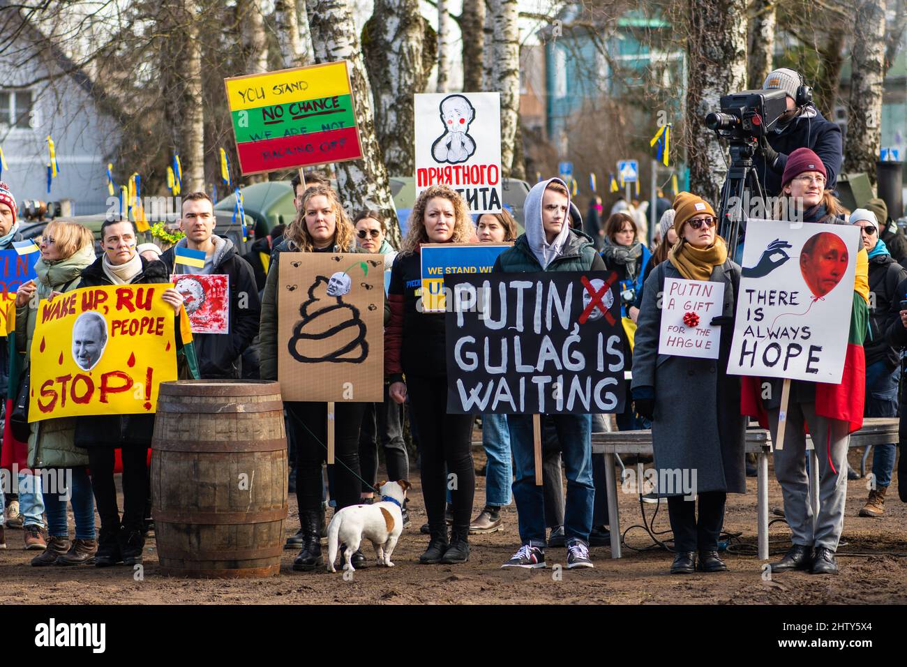 Peaceful demonstration against war, Putin and Russia in support of Ukraine, with young people, dog, placards and flags, stop war Stock Photo