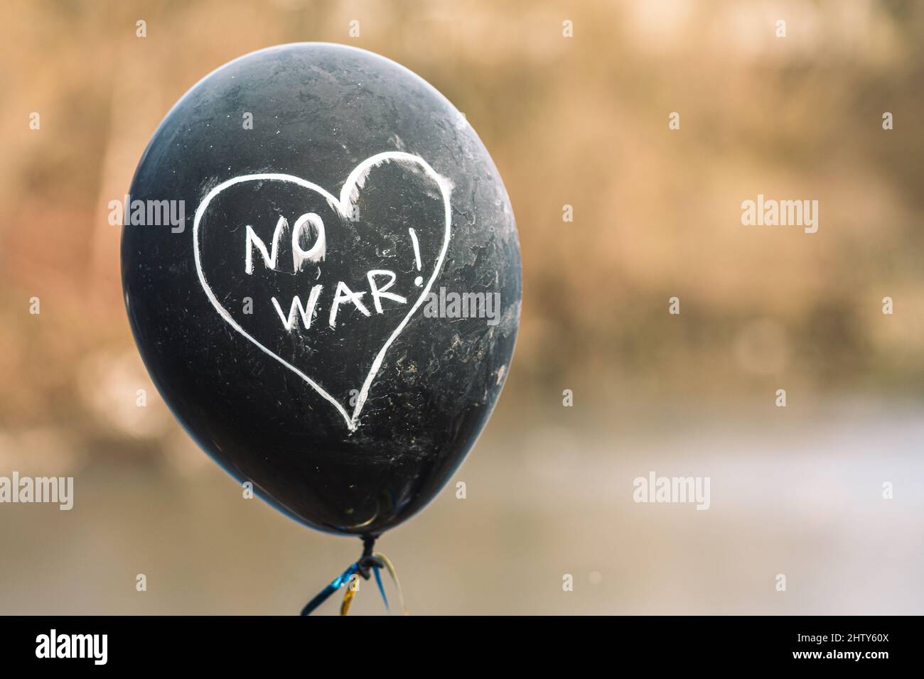 No War written in a heart on a black balloon during a peaceful demonstration against war in support of Ukraine Stock Photo