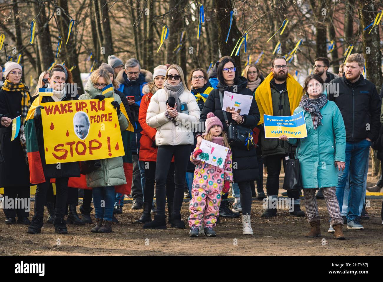 Peaceful demonstration against war, Putin and Russia in support of Ukraine, with people, children, placards and flags, stop war Stock Photo